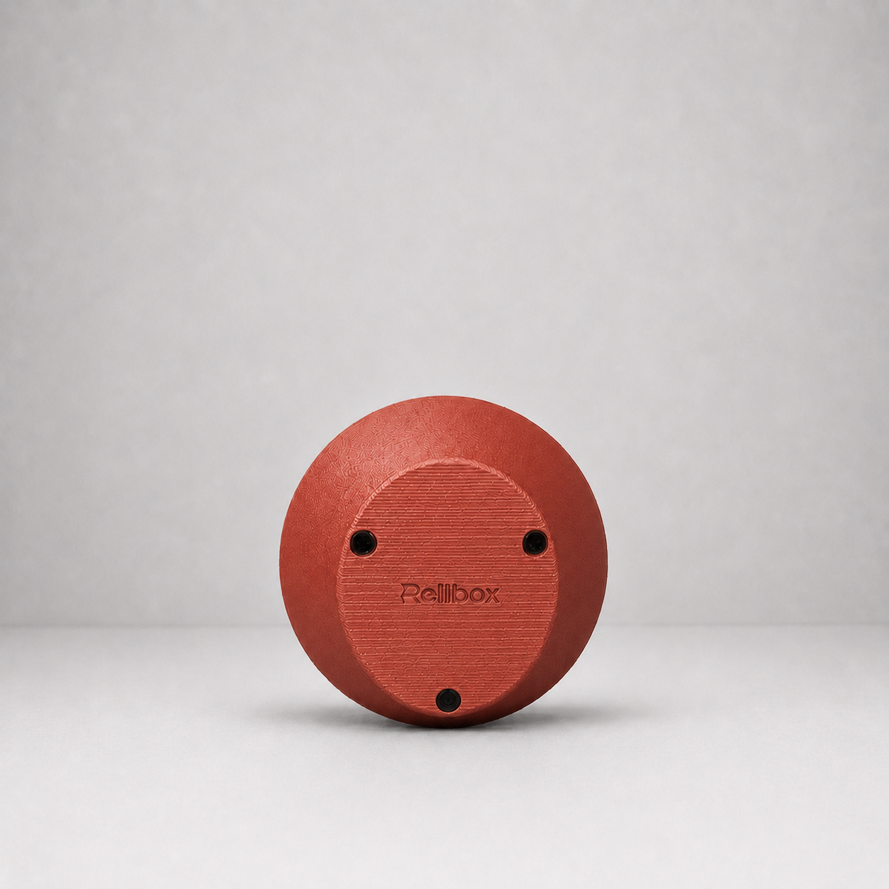 Bottom view of Rollbox Serve Clay showing the weighted base, grip feet and Rollbox logo