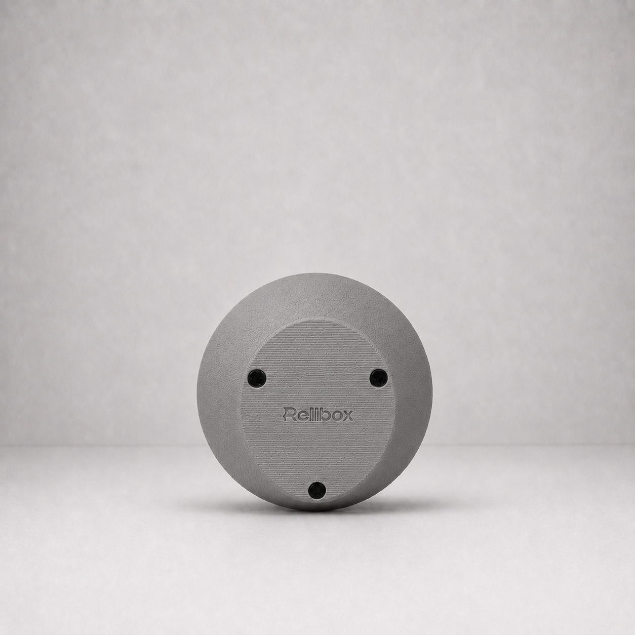 Bottom view of Rollbox Serve Stone showing the weighted base, grip feet and Rollbox logo