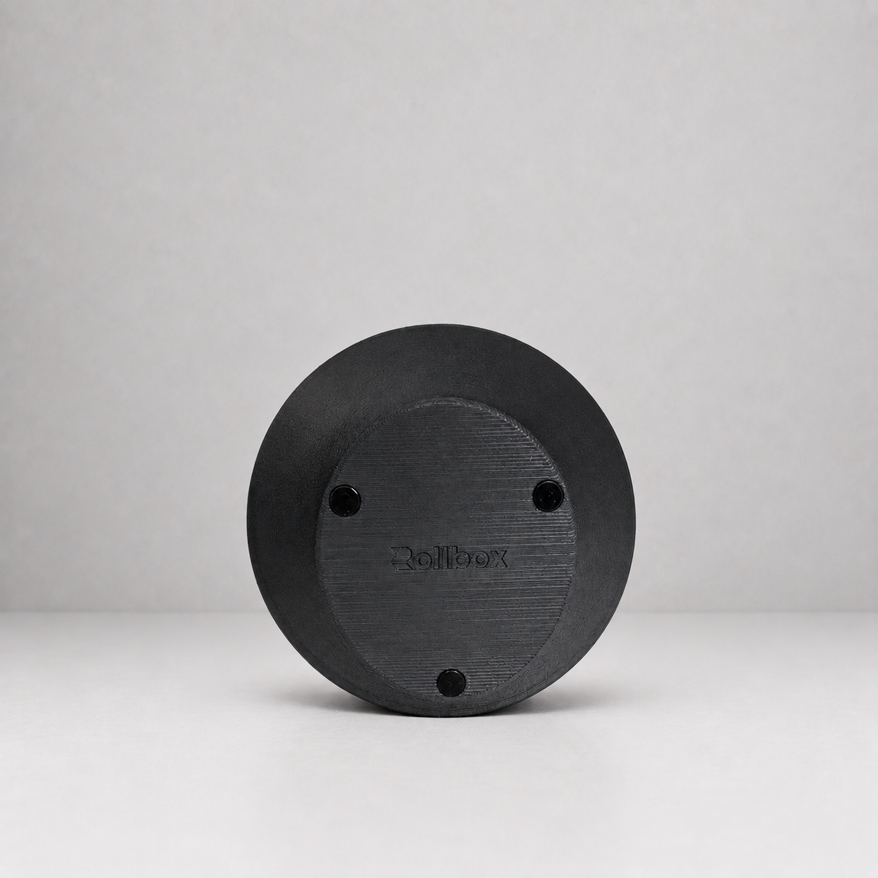 Bottom view of Rollbox Studio Blackout showing the weighted base, grip feet and Rollbox logo