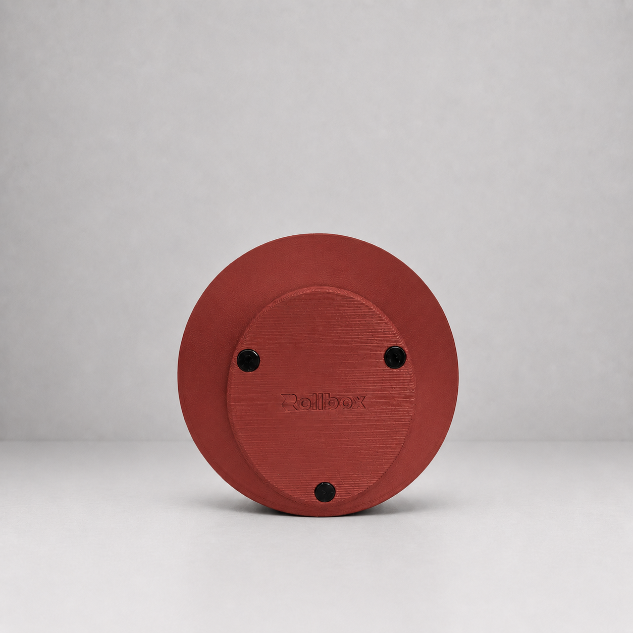 Bottom view of Rollbox Studio Clay showing the weighted base, grip feet and Rollbox logo