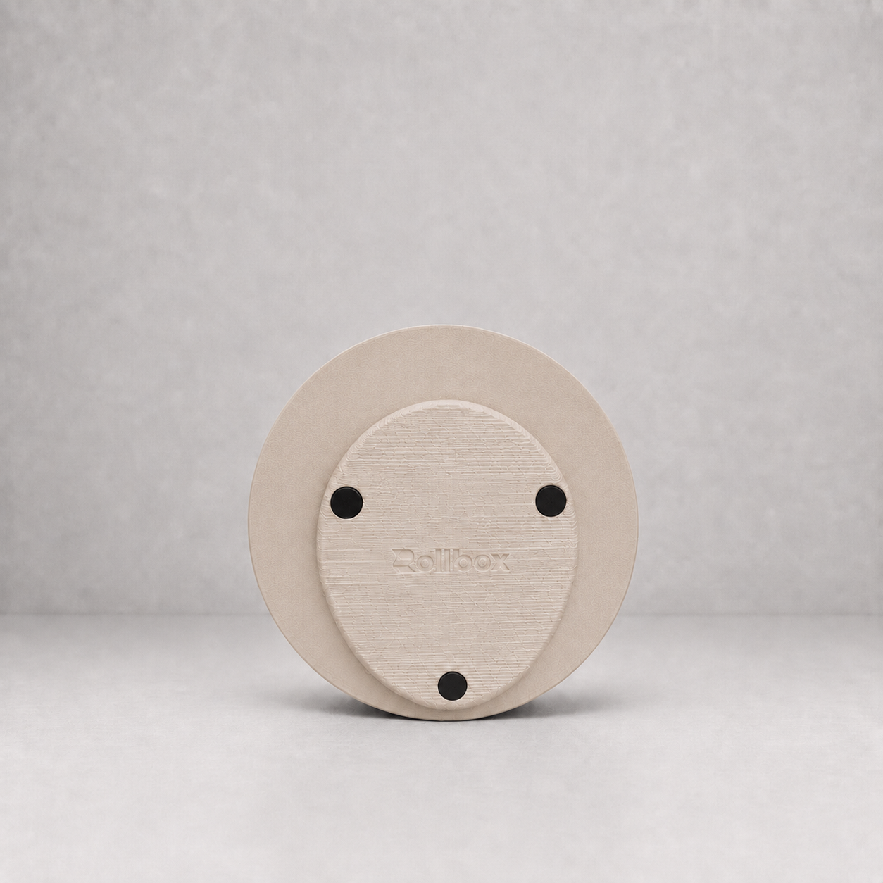 Bottom view of Rollbox Studio Dune showing the weighted base, grip feet and Rollbox logo